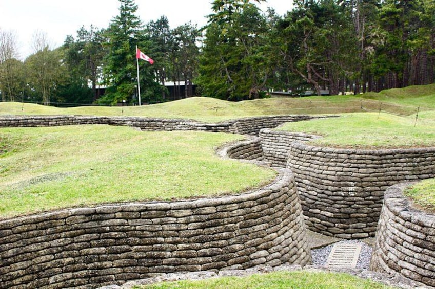 A historical site with stone walls and grassy areas. 1