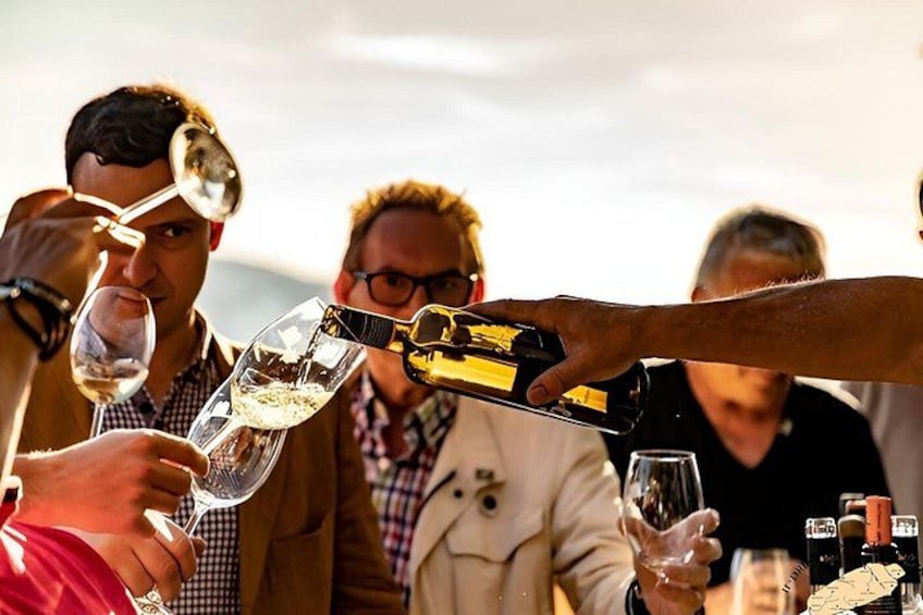 People toasting with wine glasses, holding a bottle, and a bottle of champagne. 5
