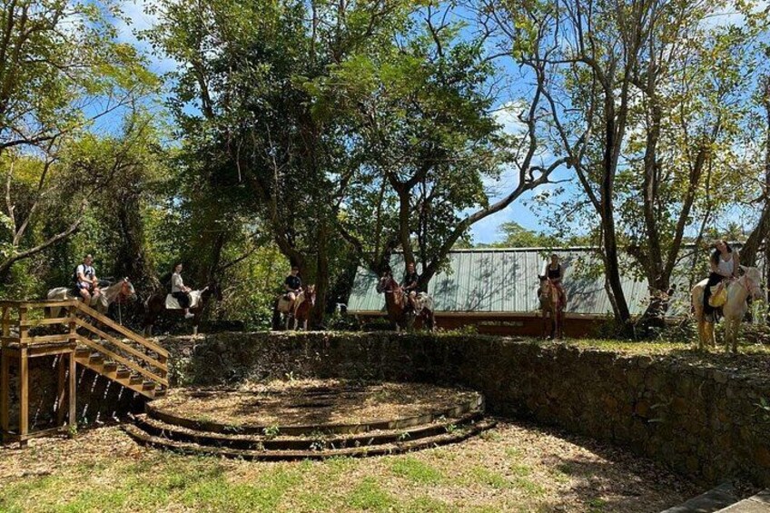 A historical site with a stone staircase and people riding horses. 3