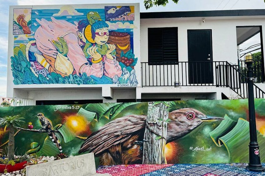 A mural with vibrant colors and wildlife illustrations, including a bird and a turtle, on a building facade. 5