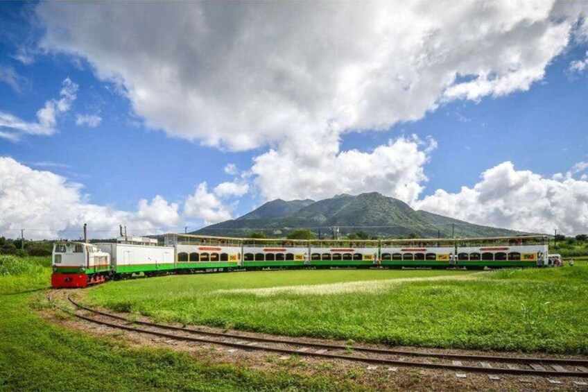 A train on tracks with a mountainous background. 1