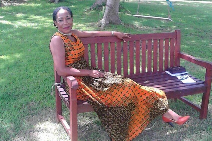 A person sitting on a wooden bench in a park. 5