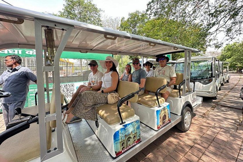 Our group of travellers heading to taj mahal from parking on a golf cart in pollution free zone 3