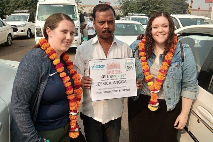 driver picking up guests with flowers at train station 5