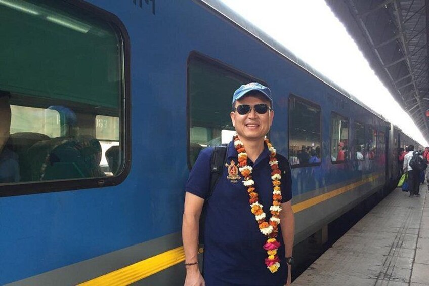 A person standing next to a train at a station. 2