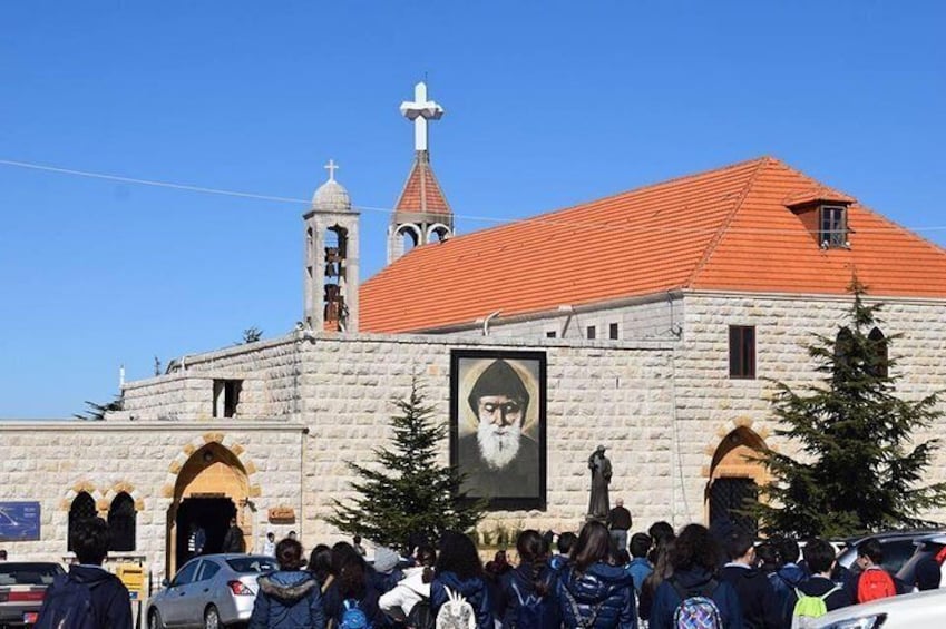 A stone church with a red roof and a bell tower. 1