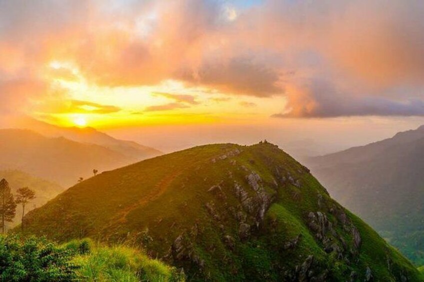 A mountain landscape during sunset with a clear sky and distant mountains. 2