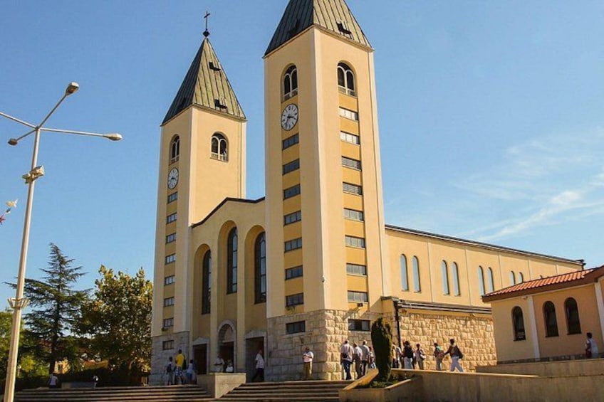 A church with two towers and a clock on each. 2