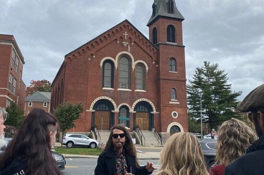 A brick church with a steeple and arched windows. 2