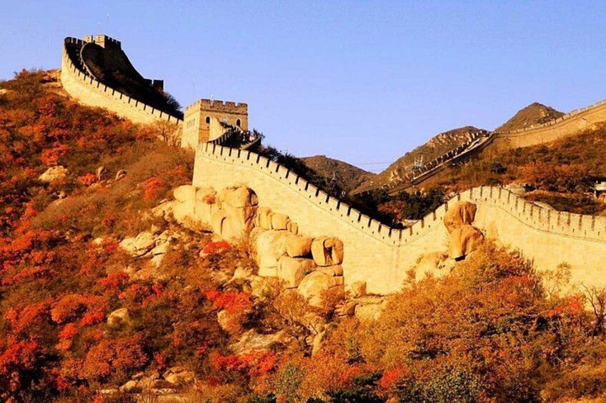 The Great Wall of China, a long wall with watchtowers, winding through a mountainous landscape with autumn foliage. 3
