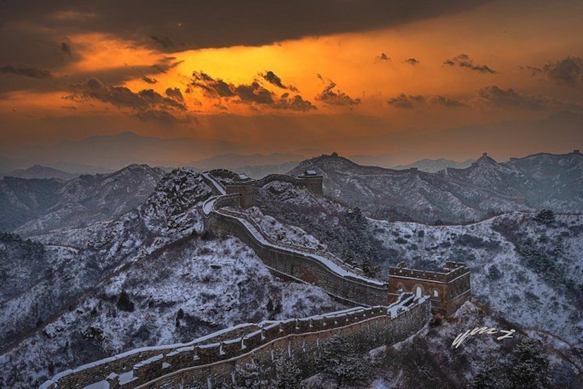 The Great Wall of China in a snowy landscape with a sunset. 5