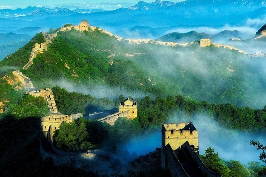 The Great Wall of China, lush green hills, and misty mountains in the background. 4