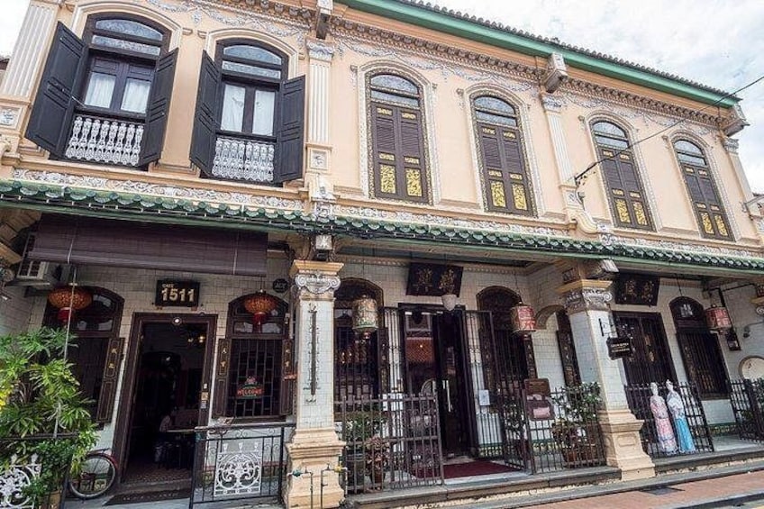 A historic building with ornate architectural details, including multiple windows with shutters and a prominent number '1511' on the facade. 5