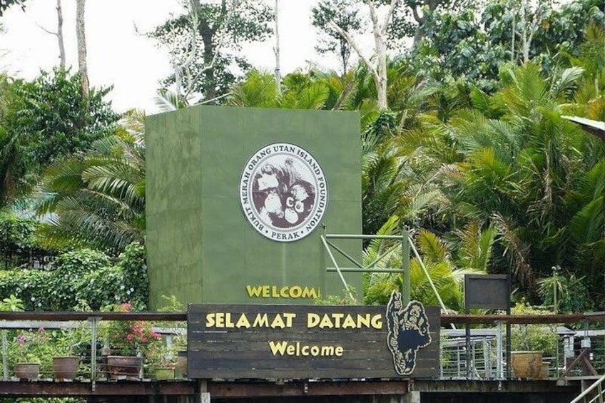 A welcome sign with a logo and the text 'Welcome Selamat Datang' against a backdrop of lush greenery. 3