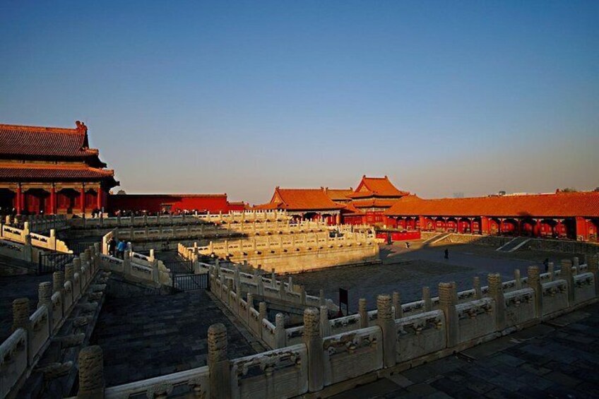 A traditional Chinese architectural complex with red-tiled roofs and stone walls. 4
