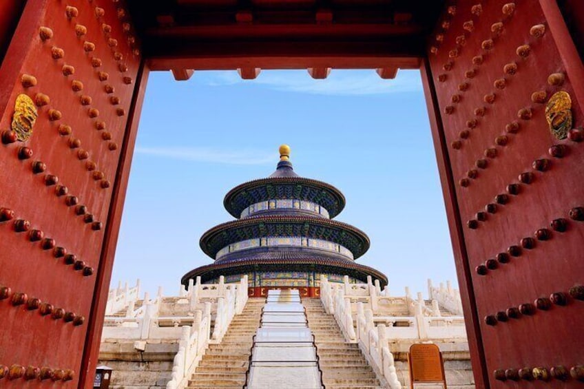 A traditional Chinese temple with a multi-tiered pagoda, red wooden gates, and stone steps leading up to it. 3