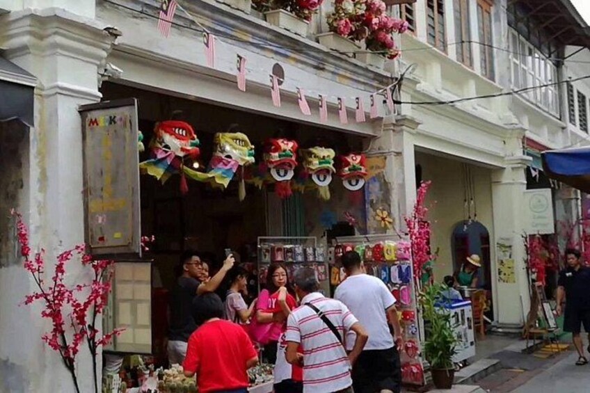 A street market with traditional decorations and a shop with colorful items. 3