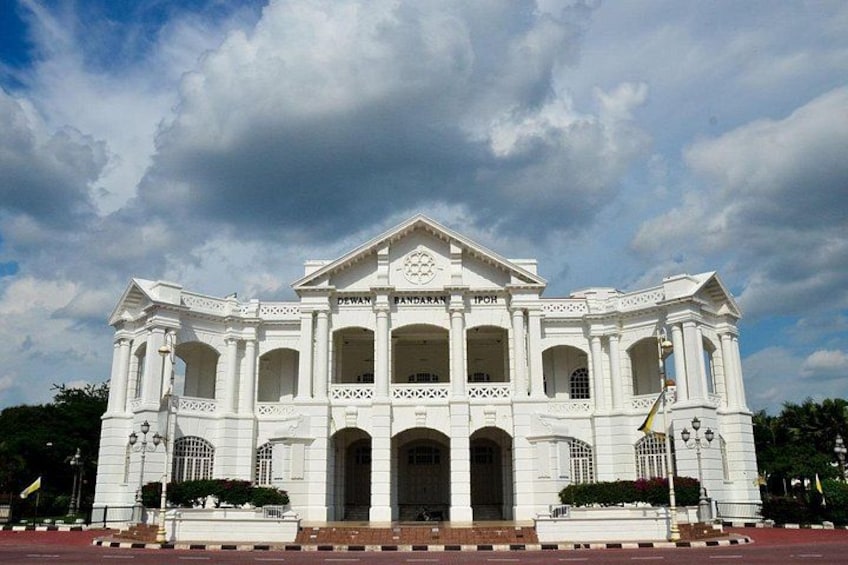 A white colonial-style building with a central dome, columns, and a flagpole. 2