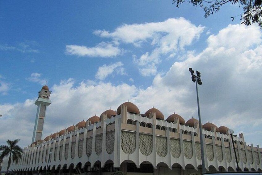 A mosque with a tall minaret and multiple domes. 2