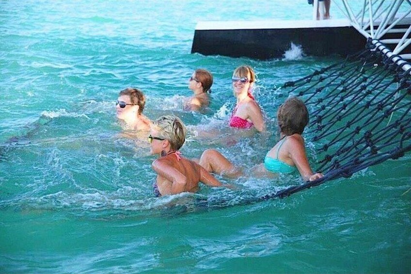 People in a pool with a hammock. 2