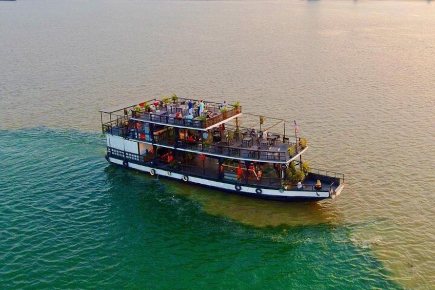 A large boat with multiple decks and people on it. 1