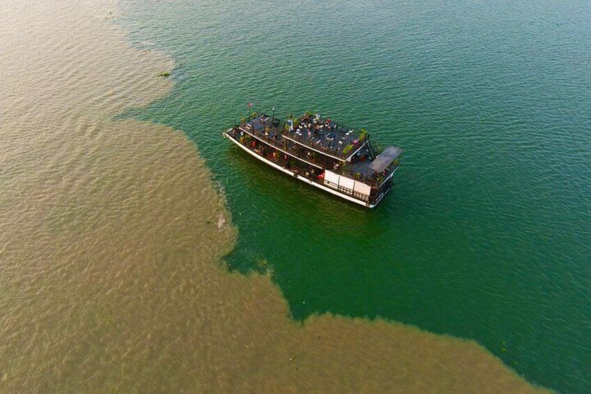A boat on a body of water with a distinct green and brown color pattern. 3