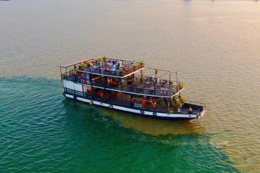 A large boat with multiple decks and people on it. 1