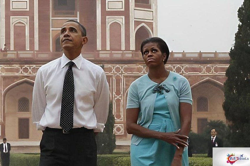 A man and a woman standing in front of a large, ornate building with arches and columns. 1