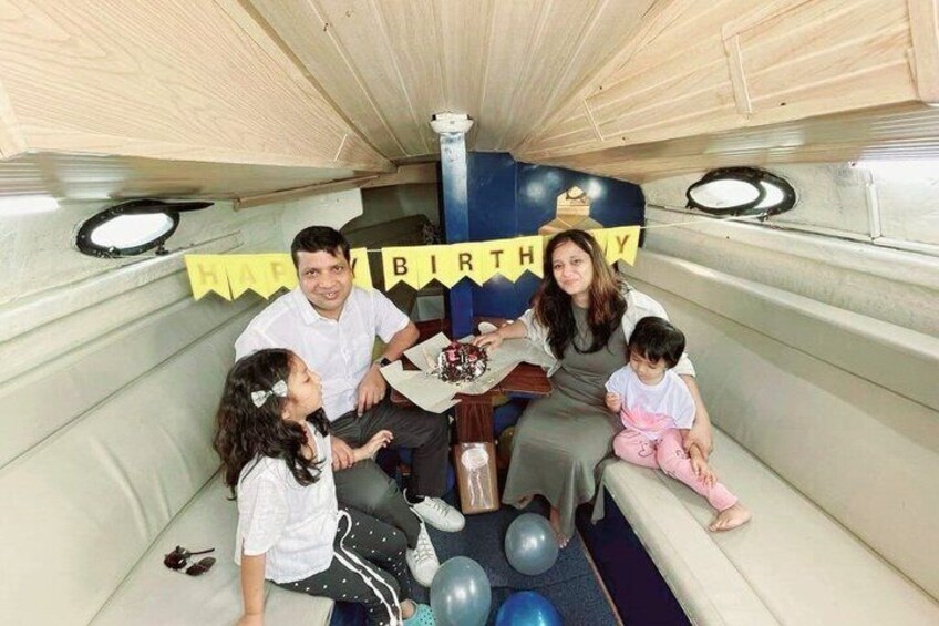 A birthday party in a wooden booth with a 'HAPPY BIRTHDAY' banner. 4