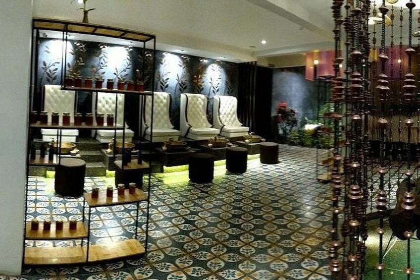 A modern interior with patterned flooring, a seating area, and decorative elements. 4