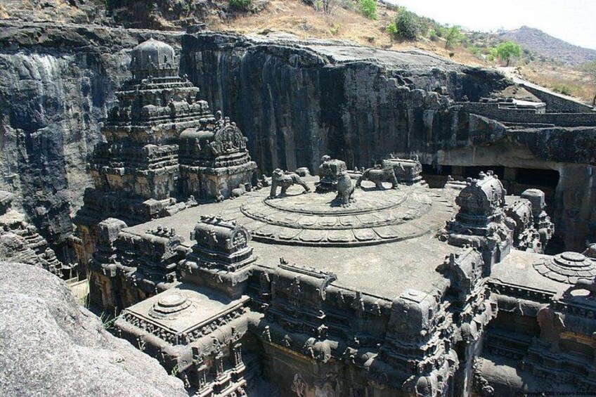 A rock-cut temple complex with multiple shrines and intricate carvings. 1