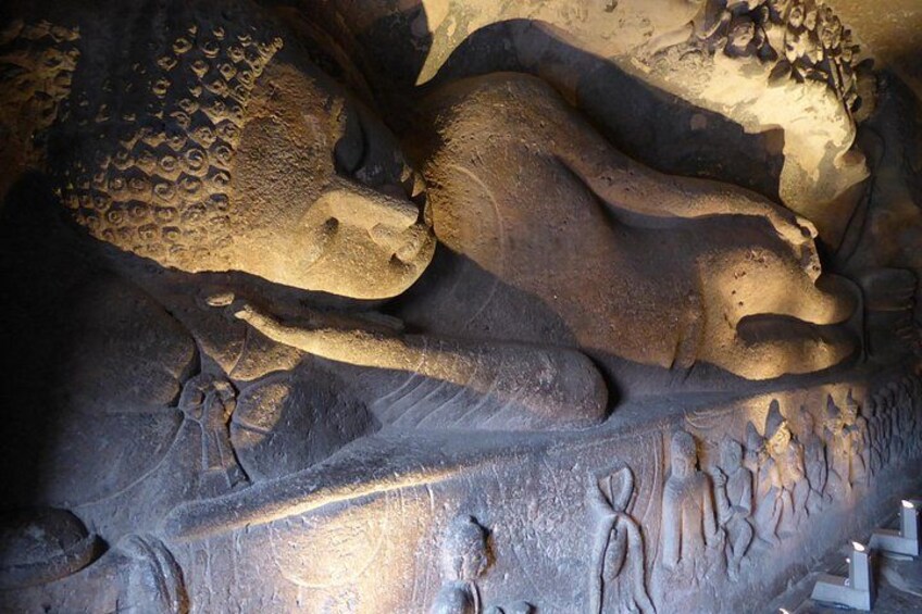 A cave with prehistoric animal carvings, including a large bison and a smaller animal. 3