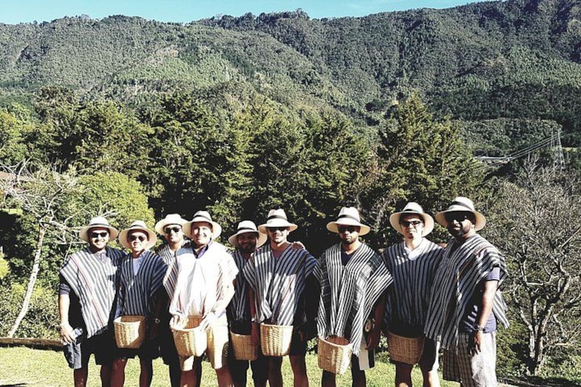A group of people standing outdoors with a mountainous landscape in the background. 4