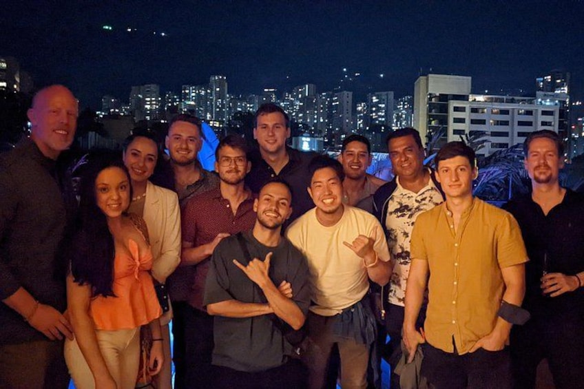 A group of people posing for a photo with a city skyline in the background. 2
