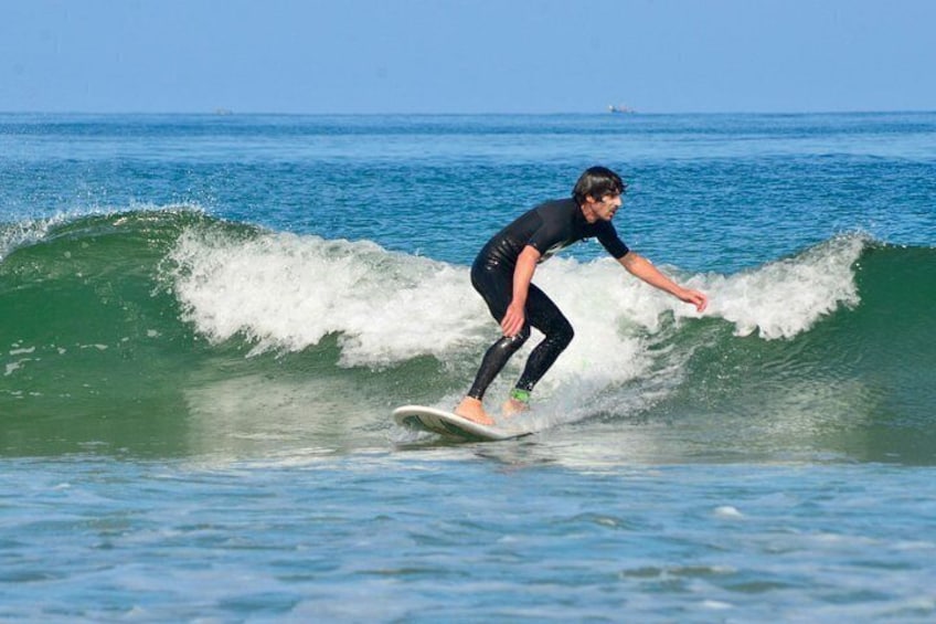 A person surfing a wave in the ocean. 1