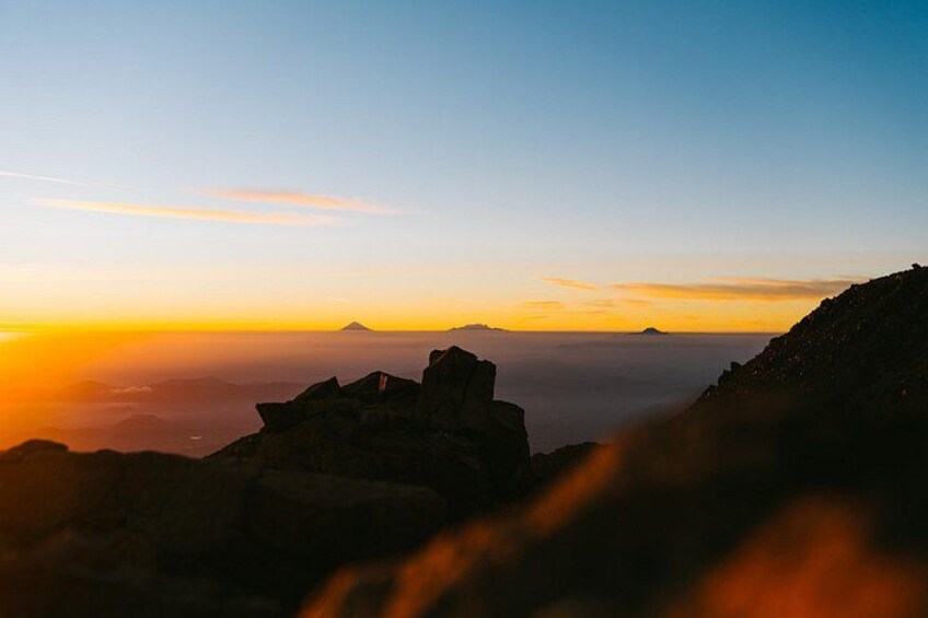 A mountainous landscape at sunset with a clear sky. 2