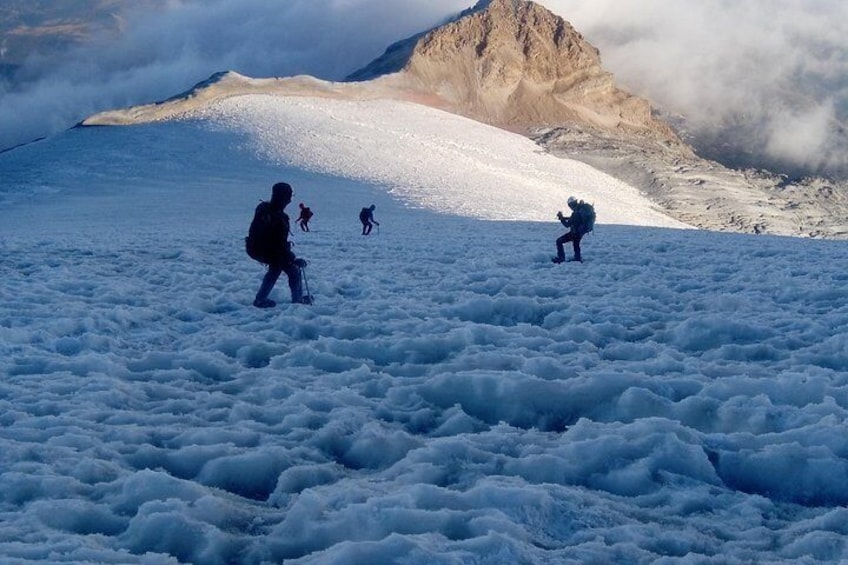A snowy mountain landscape with hikers. 3