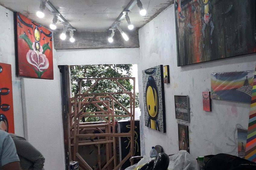An art gallery with various paintings and sculptures. 5