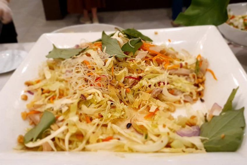 Een bord met een salade van gesneden groenten en kruiden. 5