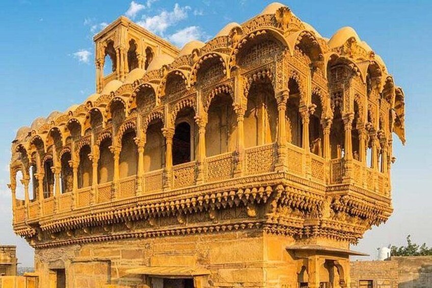 A historic building with intricate carvings and multiple arches. 1