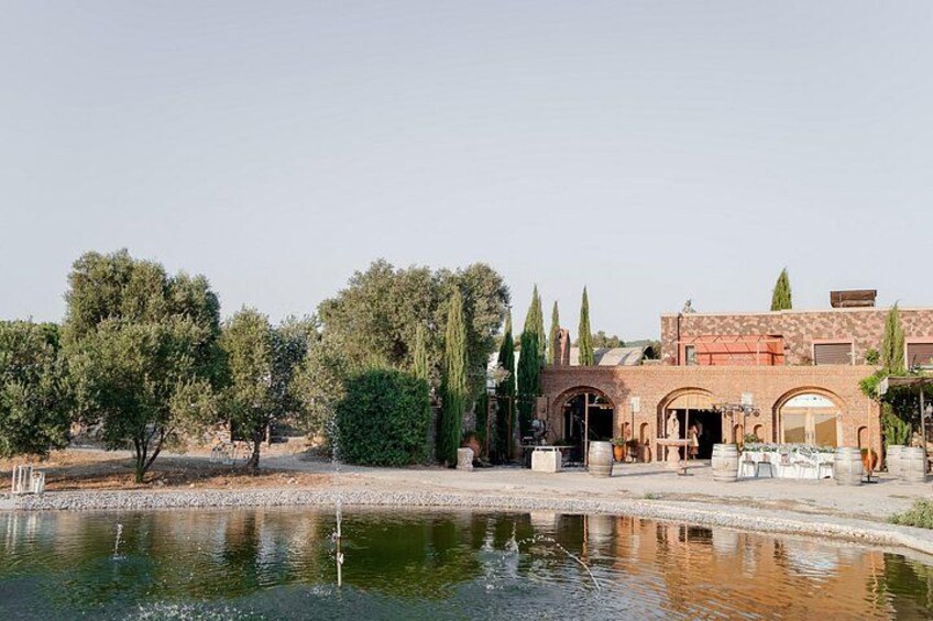A building with arched windows and a courtyard with a water feature. 1