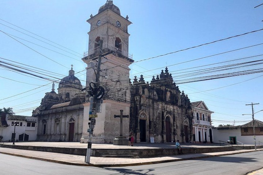 A historic church with a bell tower, domes, and a cross. 3