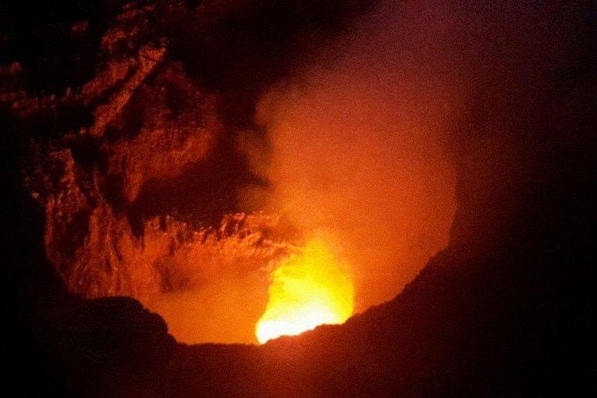 A volcanic eruption with lava flowing from a crater. 4