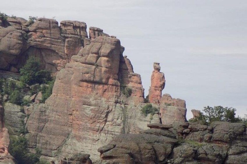 A rugged rock formation with layered sedimentary structures. 1