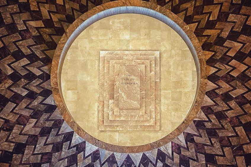 A circular mosaic with a central square pattern and surrounding geometric designs. 2