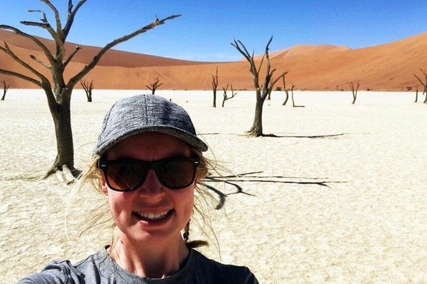 A desert landscape with sparse vegetation and a clear sky. 5