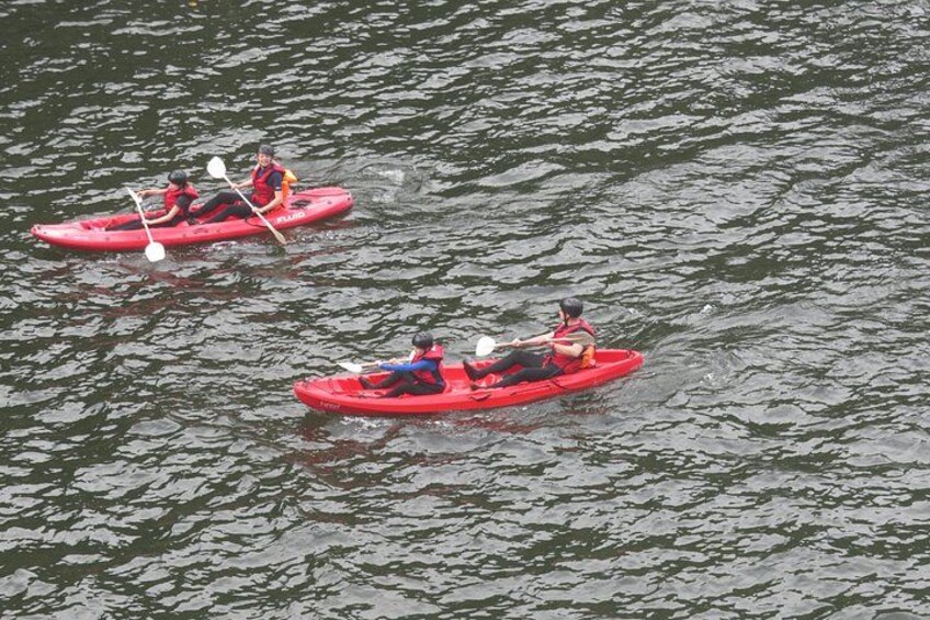 Two people kayaking on a calm body of water. 2