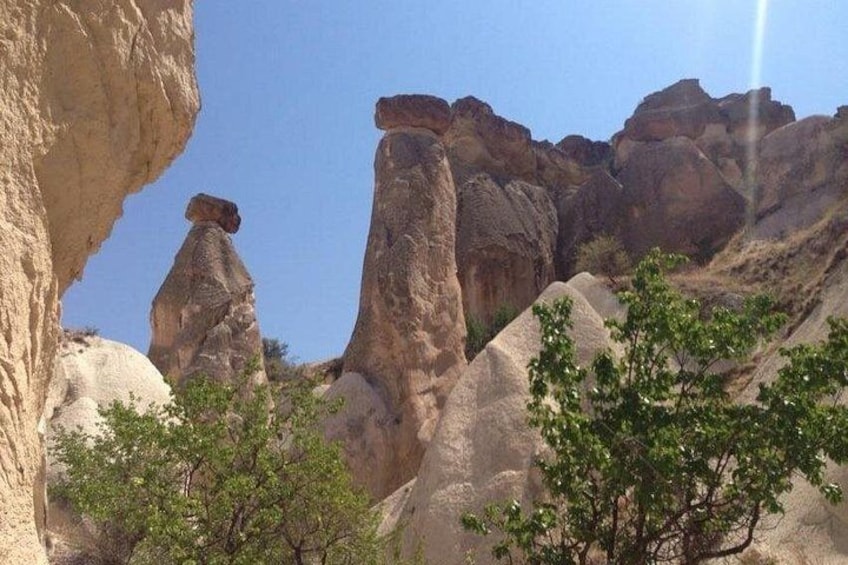 A rocky landscape with prominent rock formations and sparse vegetation. 1