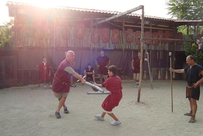 A group of people playing a game with bats and balls in an outdoor setting. 3