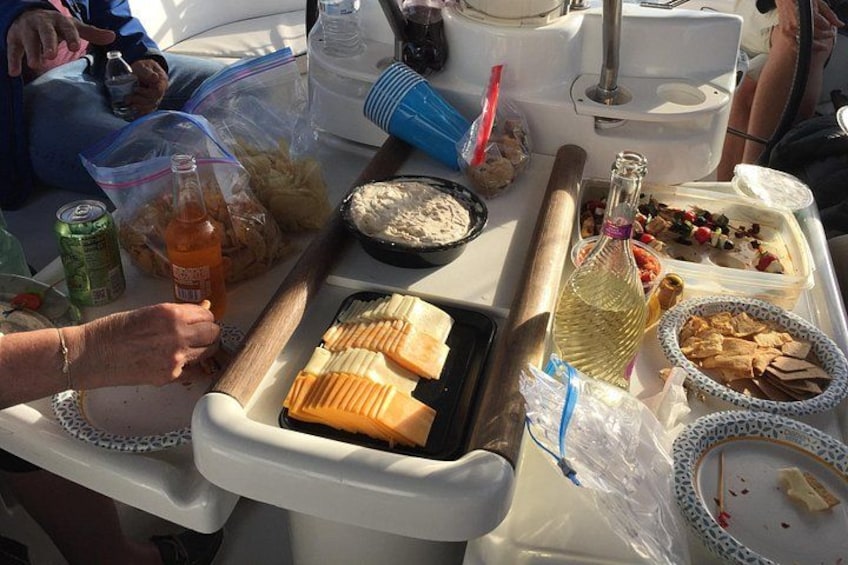 A table with food items, a bottle, and a container. 2
